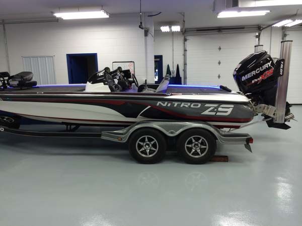 Nitro Z9 bass boat on a trailer, black, red, and white design, in a garage.