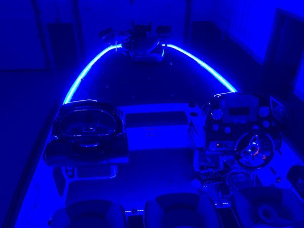 Interior of a cockpit illuminated with blue neon lights.