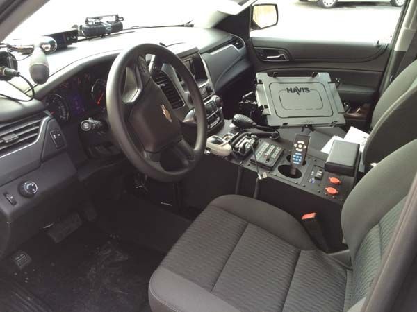 Interior of a Chevrolet police SUV with equipment console and computer.