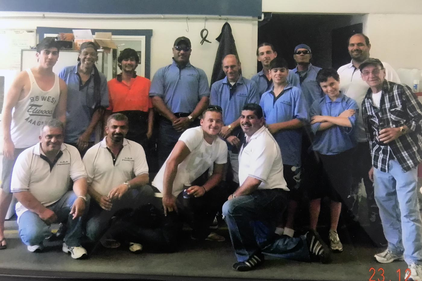 Group of people in work attire posing for a photo, indoors.