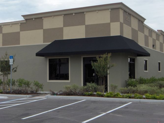 Black awning on a modern commercial building.