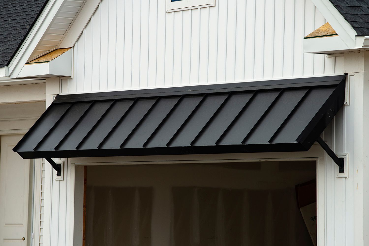 Black metal awning showcasing durability and protection on a building exterior. Black metal awning showcasing durability and protection on a building exterior.