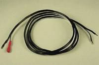 Black cable with red and black alligator clips coiled on a beige surface