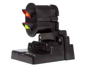 Miniature black traffic light with red and green lights on a stand