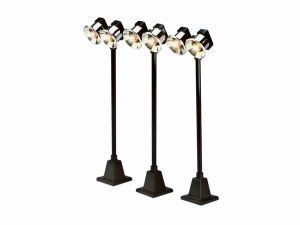 Three black spotlight floor lamps with adjustable heads on square bases.