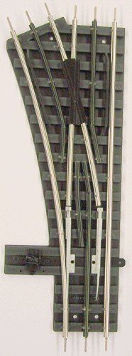 Model railroad track turnout on a white background