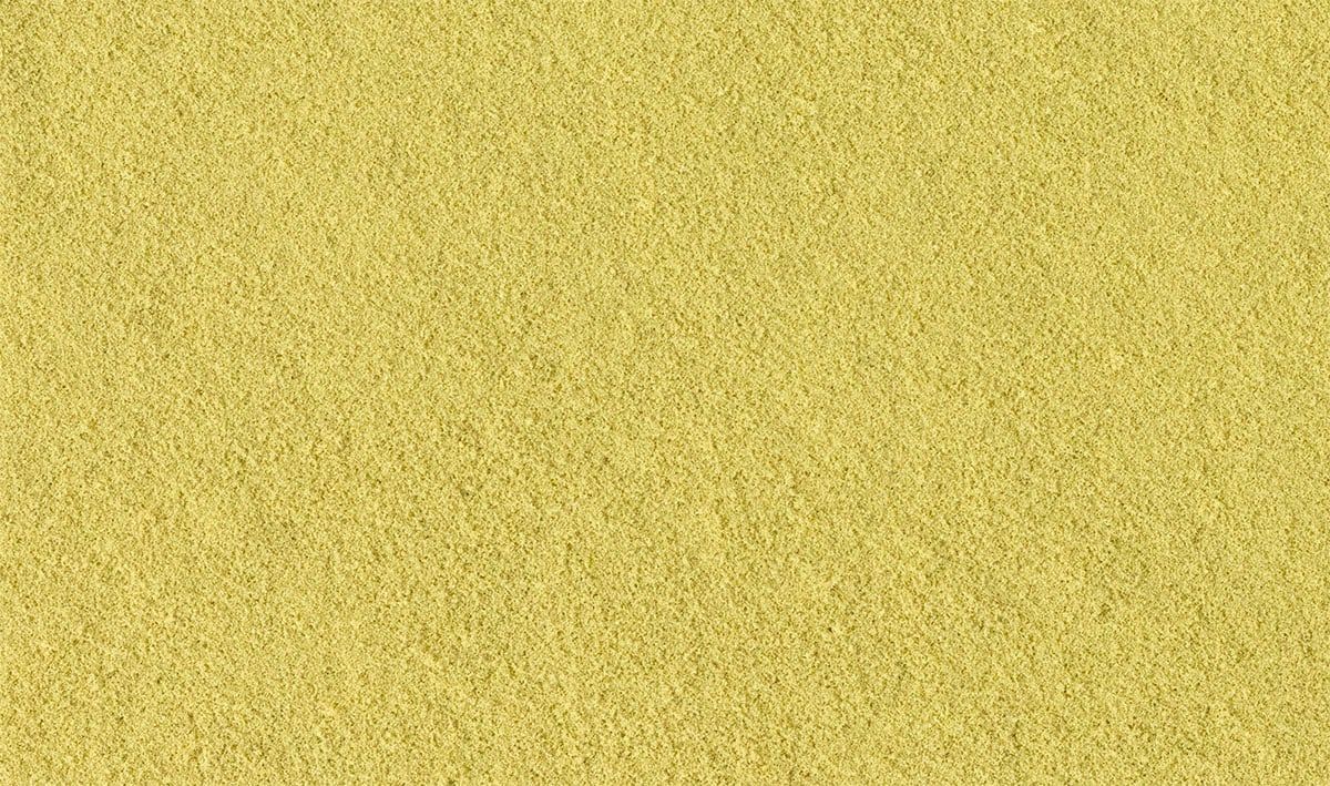 Close-up of a yellow textured surface with fine speckled pattern