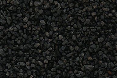 Dark close-up of small black stones or gravel covering the entire frame