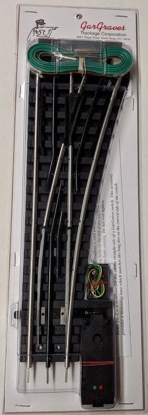 Blister pack of black zip ties with a green handle tool at the top