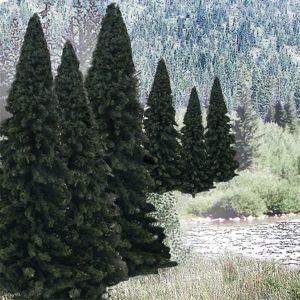 Tall dark green conifer trees line a riverbank with snowy mountains in the background.