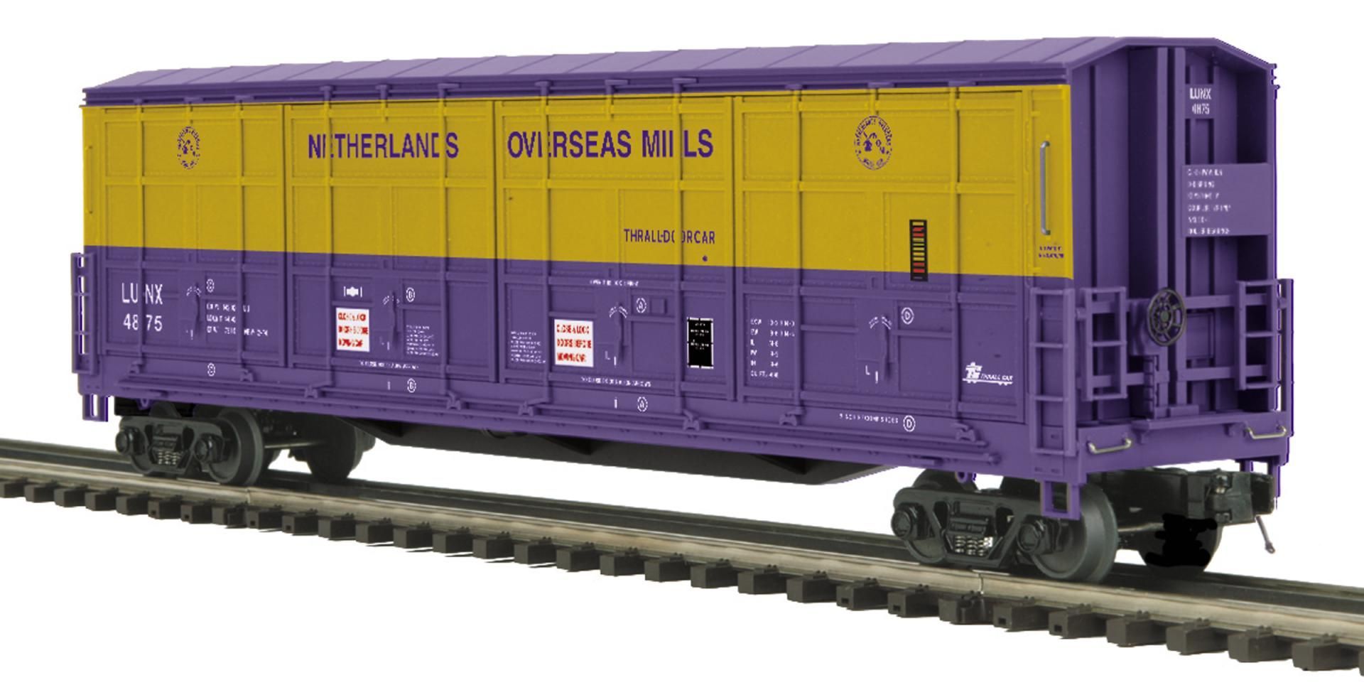 Purple and yellow boxcar on railroad tracks, side view