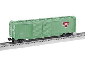 Green model boxcar on train tracks with a red logo on the side