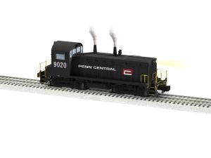 Black Penn Central diesel switcher locomotive 9020 on tracks, with smoke rising from both stacks.