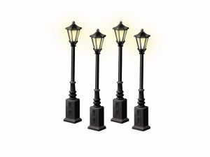 Four black decorative street lamps on square bases, arranged in a row on a white background
