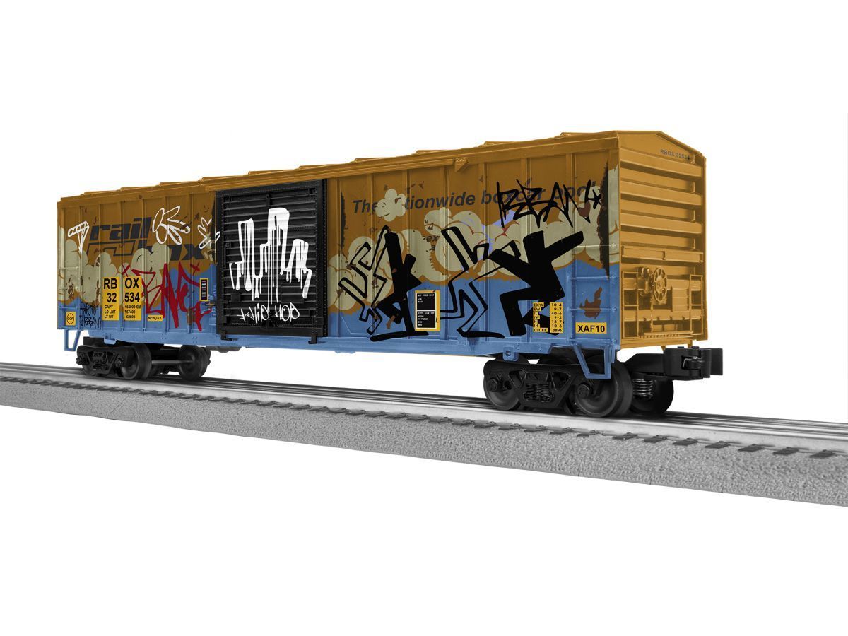 Graffiti-covered yellow boxcar on railroad tracks
