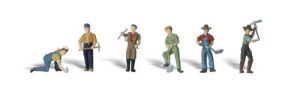 Six small figurines of people in different work poses on a white background