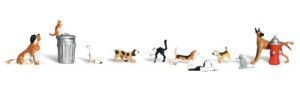 Dogs and cats line up by a trash can and fire hydrant on a white background.