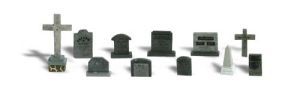 Collection of assorted black and gray tombstones and grave markers on a white background