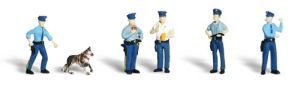 Five small figures in blue uniforms, including one kneeling with a dog, standing in a row on white background