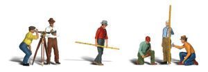 Construction workers using surveying tools and measuring a wooden post on a white background