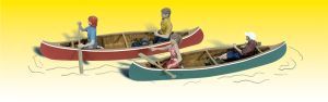 Two canoes on calm water, each with a person paddling, one red and one teal with yellow trim.