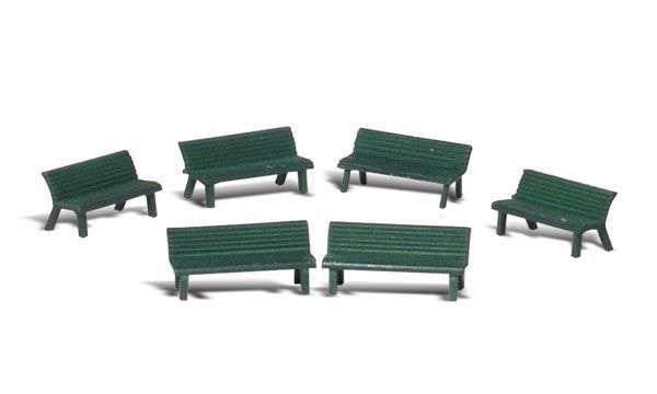 Six small green park benches arranged in two rows on a white background