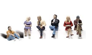 Six people sitting apart on white background, reading or using devices in casual poses.