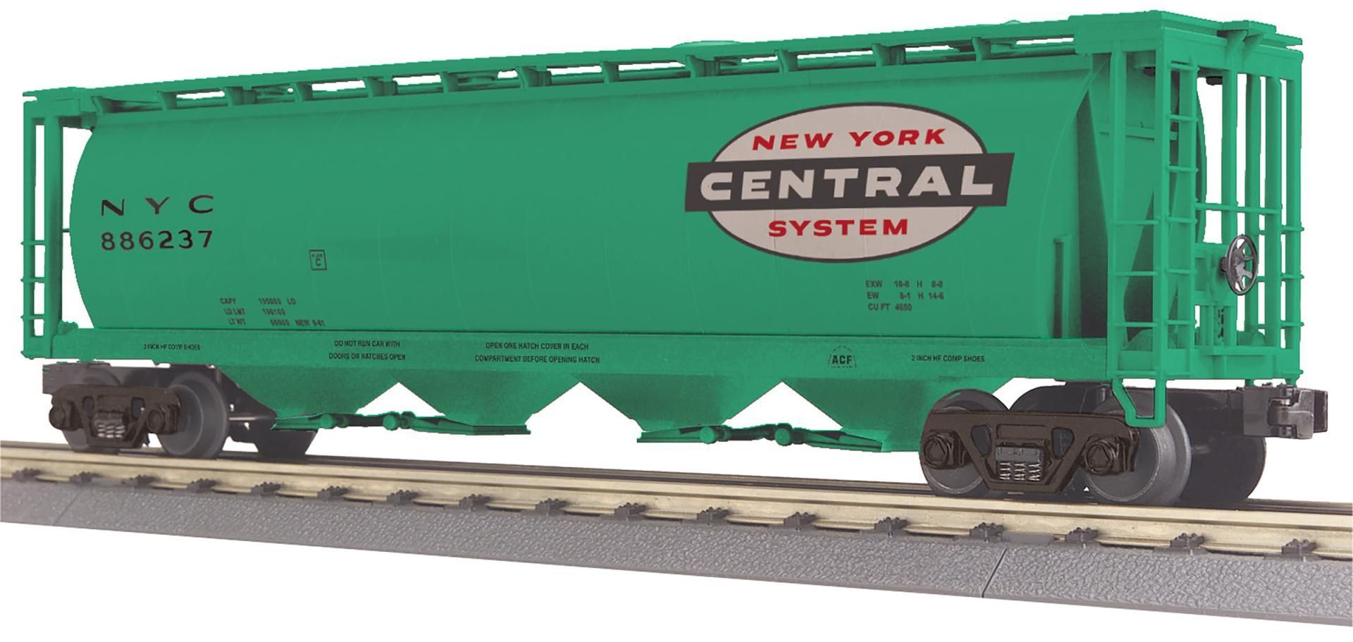Green New York Central System freight train car on tracks, side view.