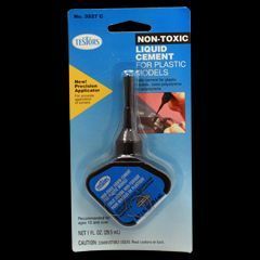 Blue package of non-toxic liquid cement for plastic models with applicator brush