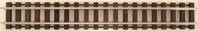 Straight section of model railroad track on a beige background