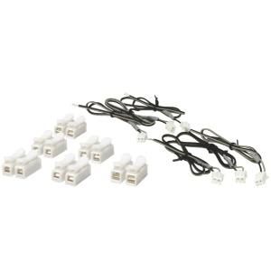 Assorted white electrical connectors with black wire harnesses on a white background