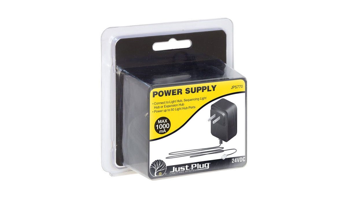 Blister-packaged black power supply adapter with yellow-and-white label on a white background