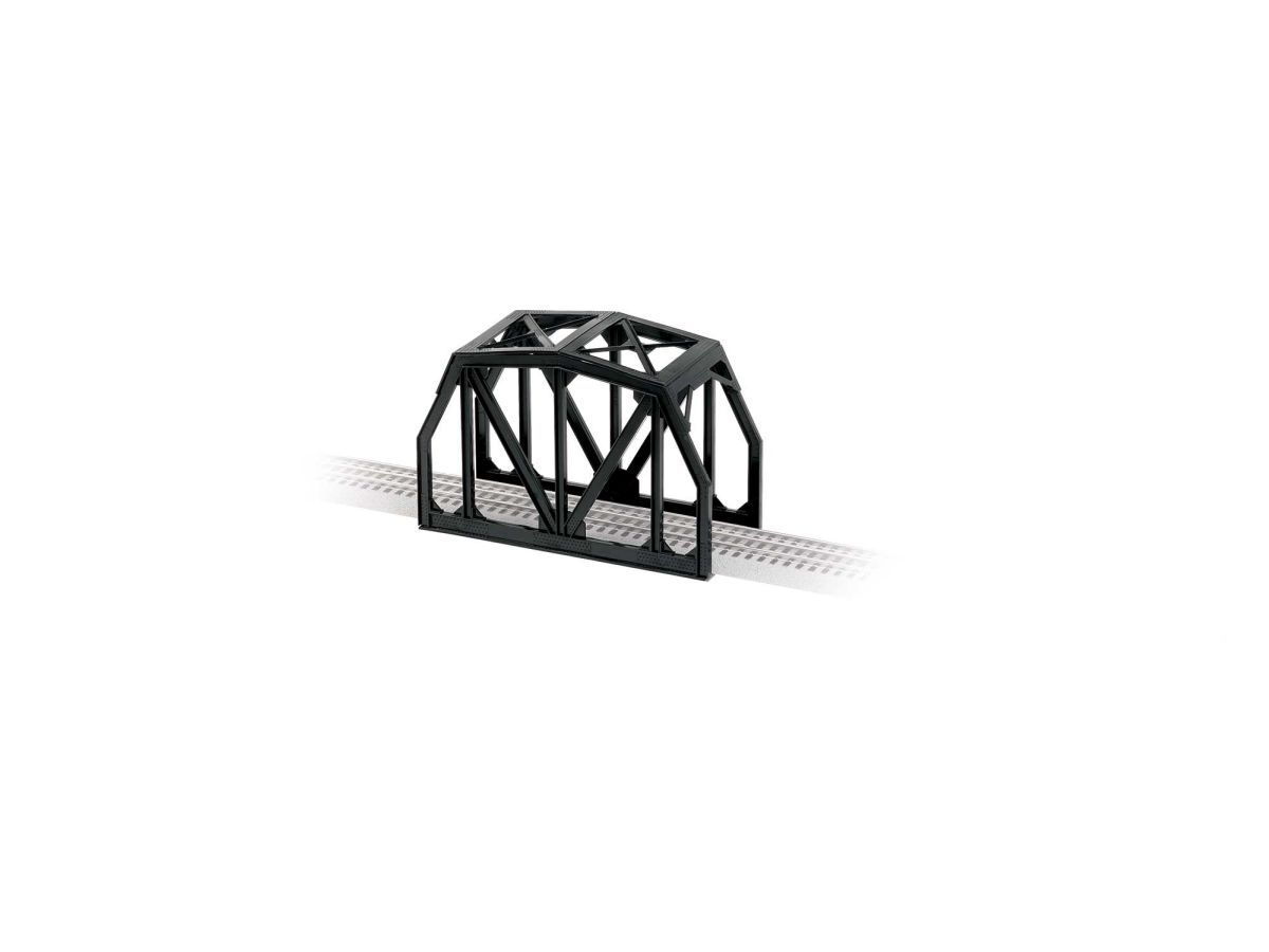 Black steel truss bridge spanning a railway track on a white background
