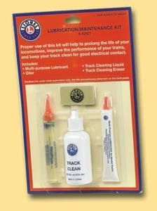 Train maintenance kit in orange packaging with cleaner bottle, lubricant, and cleaning brush/tools