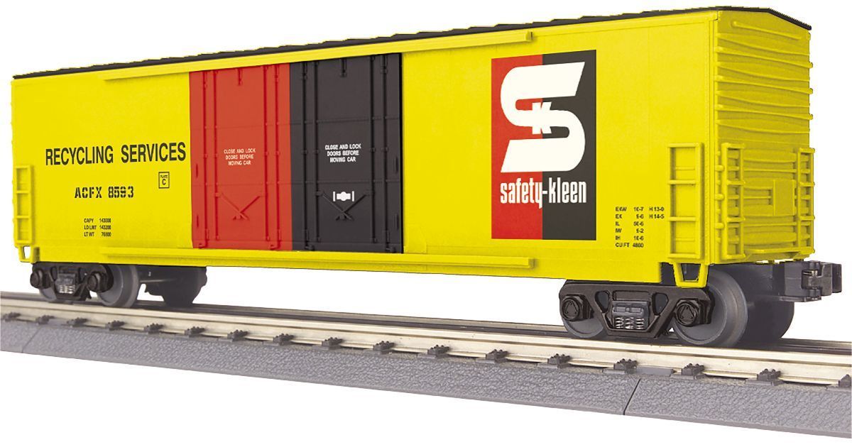 Yellow freight boxcar with red and black sliding doors and large white logo on tracks
