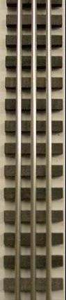 Close-up of a beige building facade with vertical rows of small dark windows or vents