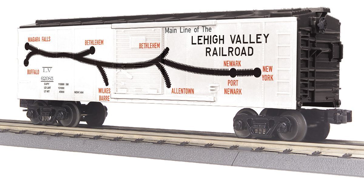 White Lehigh Valley Railroad boxcar model on tracks with black roof, orange logo, and wheels visible