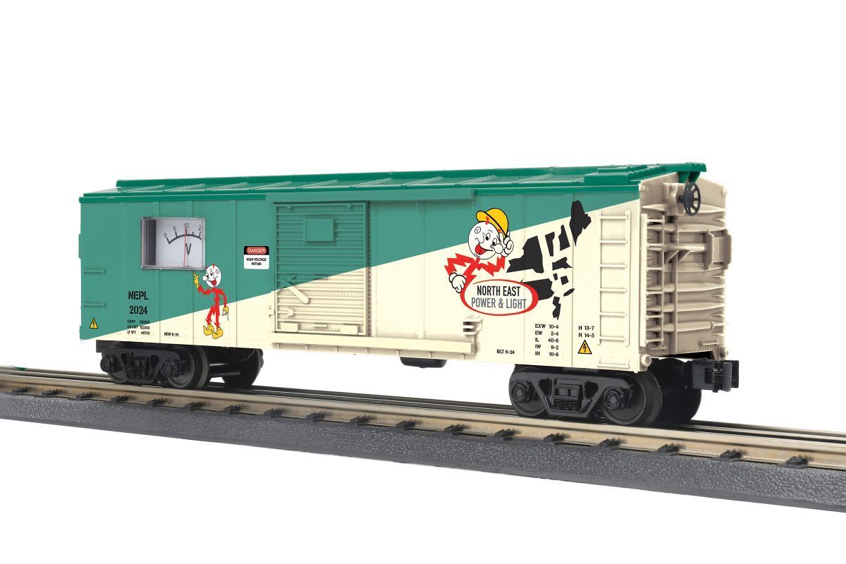 Green and cream boxcar train on tracks with holiday-themed graphics