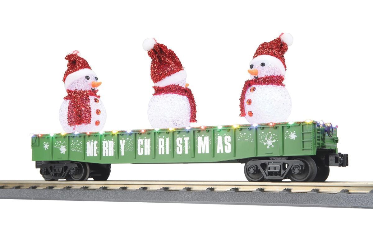 Snowman figurines on a green holiday train car on tracks