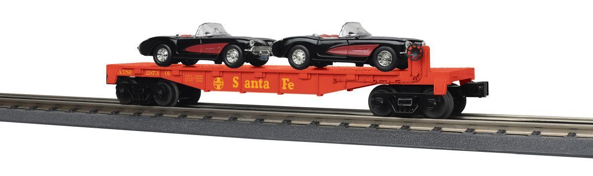 Red flatbed railcar carrying two black vintage cars on train tracks