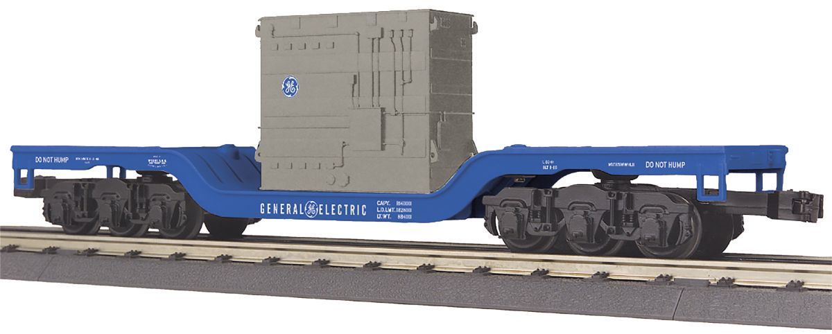 Blue flatbed railcar carrying a gray crate on tracks