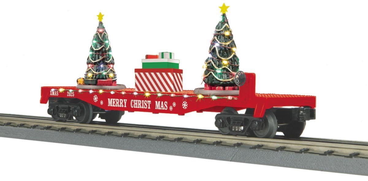 Red holiday train car with two decorated Christmas trees and gifts on tracks