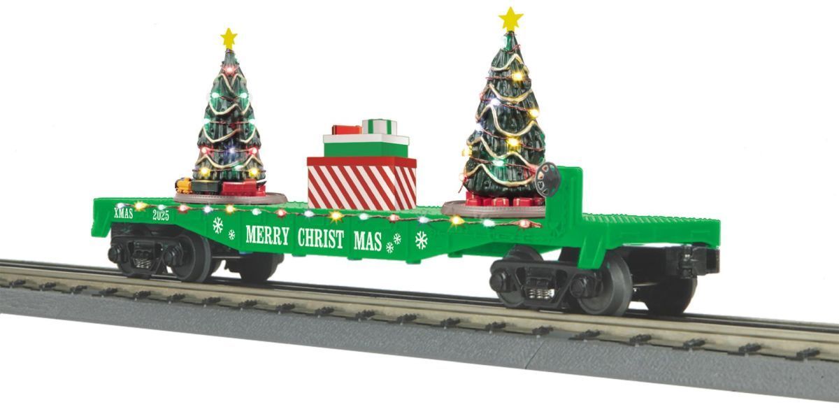 Green holiday train car with two decorated Christmas trees and gift boxes on tracks