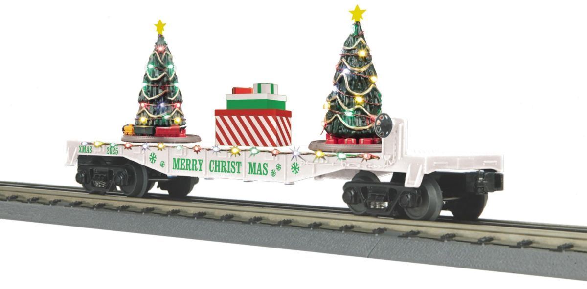 White model train car decorated with Christmas trees, gifts, and lights on tracks