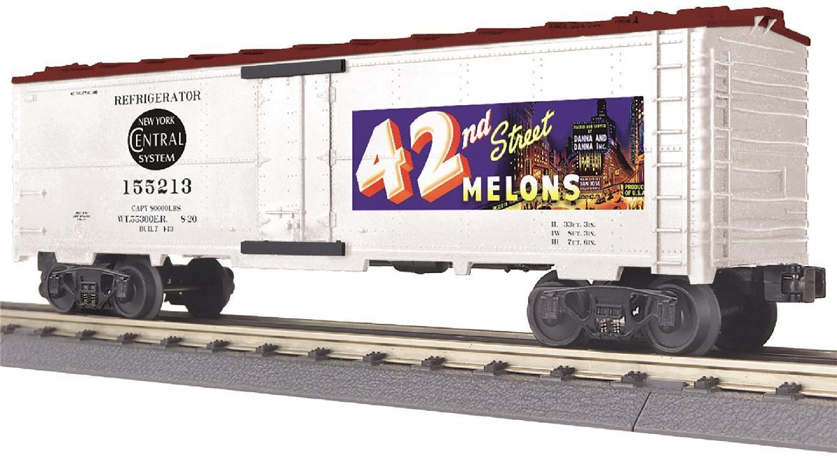 White model boxcar on tracks with black “42” and “Mile Melons” graphics on the side