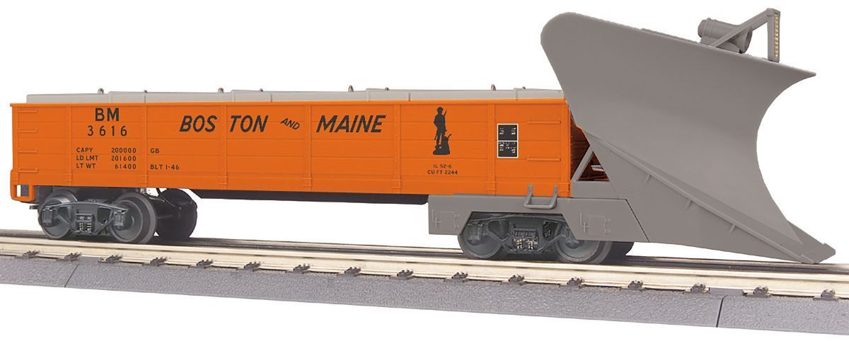 Orange and black snowplow railroad car on tracks with a large front blade raised
