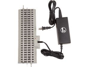 Silver vented electronic device beside a black power adapter and cable on a white background