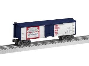 Blue Budweiser boxcar on railroad tracks with red and white logo and “This Bud’s for you” text