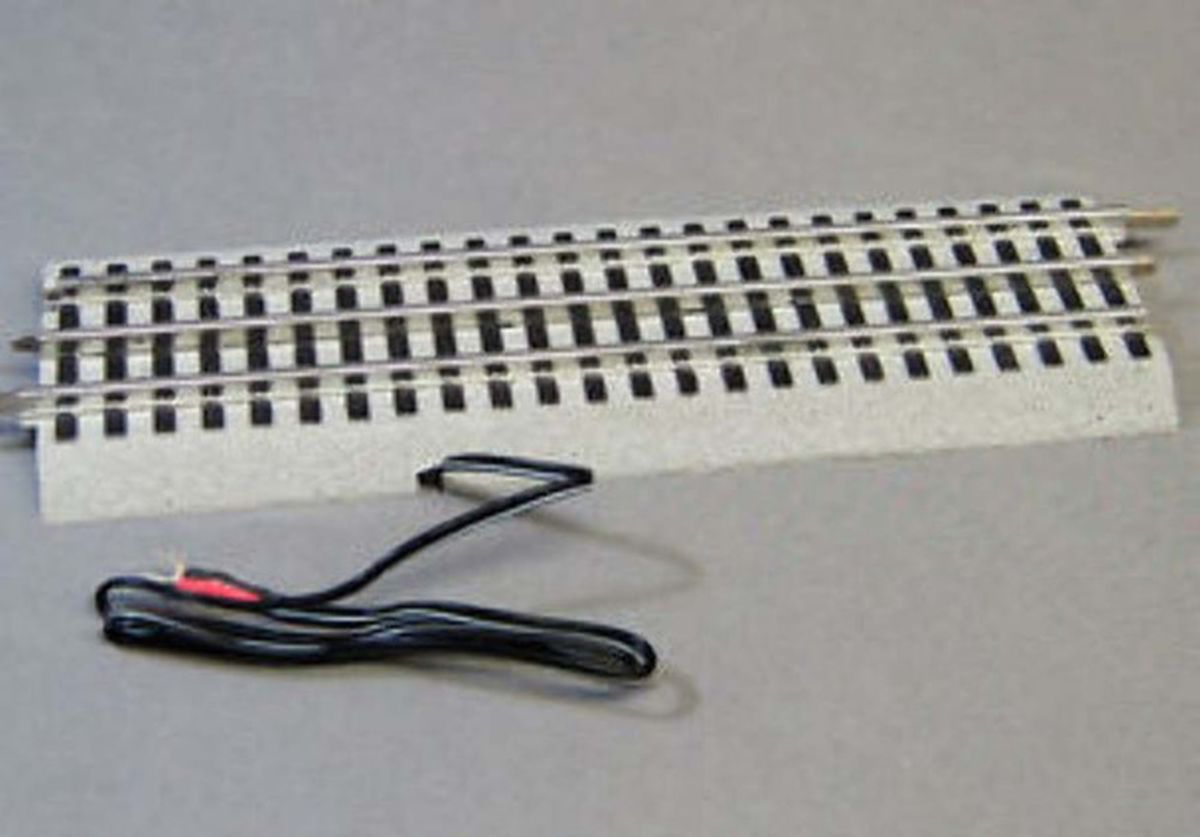 Model train track turnout switch with attached wire