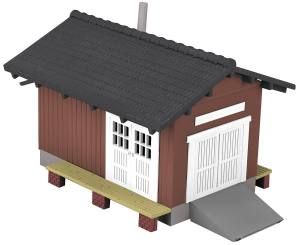 Small brown wooden house model with black roof, white doors, and a gray ramp on stilts